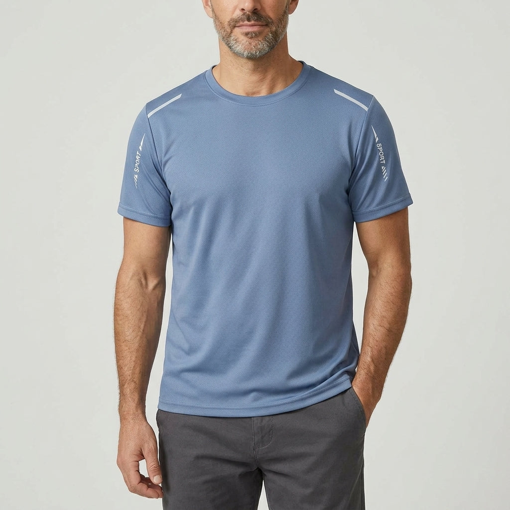 Man wearing the Davos Active Tee in Steel Blue, front view, one hand in his pocket