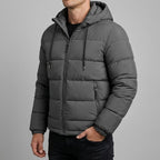 Simon Hooded Puffer Jacket in Gray, worn zipped — quilted baffles and zippered hand pocket